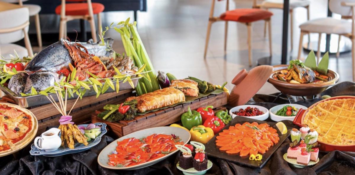 A seafood buffet spread at M Social Resort Penang featuring whole salmon, prawns, salmon Wellington and smoked salmon platters