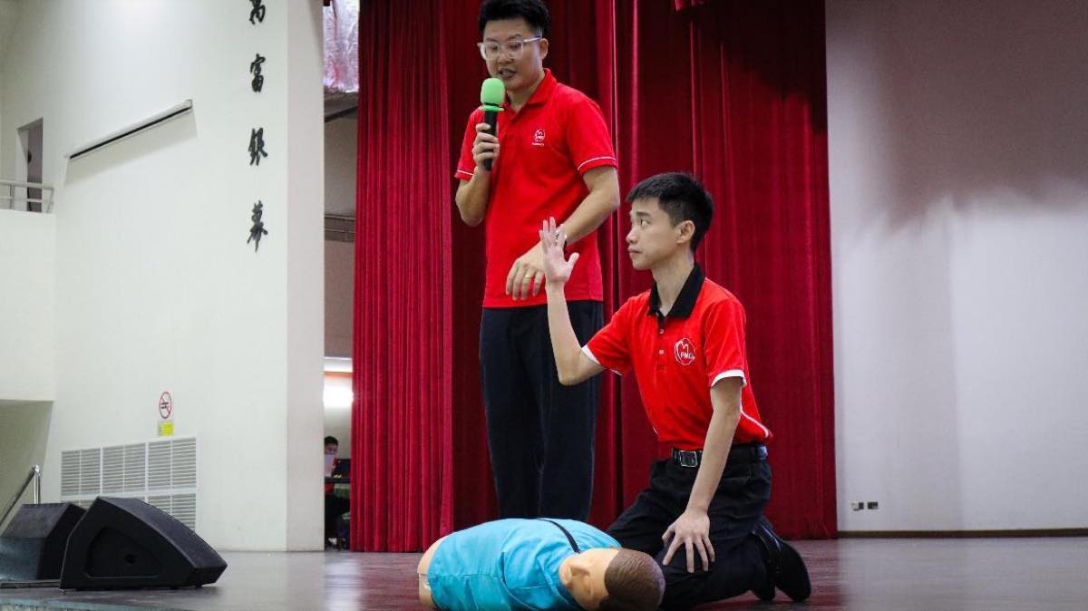 Students practise CPR on a training manikin during a PMG Healthcare Save A Life, Learn CPR session